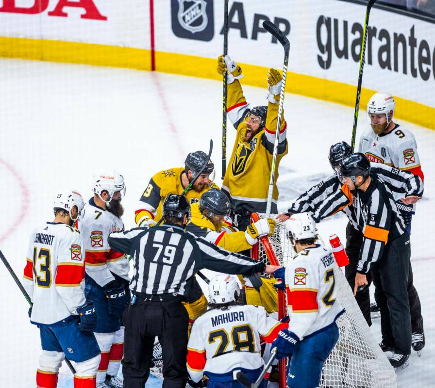 Golden Knights players celebrate a score over Florida Panthers goaltender Sergei Bobrovsky (72) ...