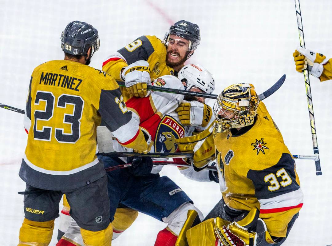 Florida Panthers defenseman Radko Gudas (7) is driven from the crease after a shot against Gold ...