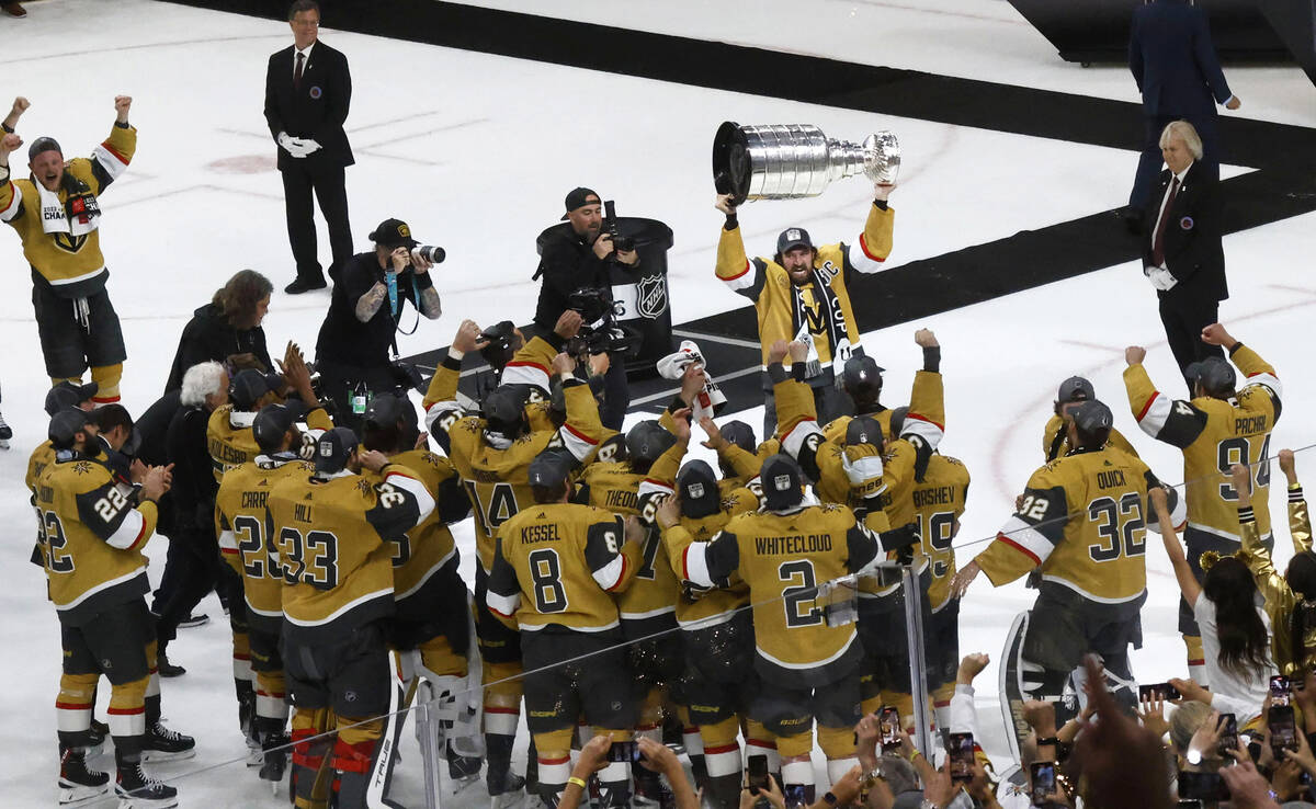 Golden Knights right wing Mark Stone (61) hoists the Stanley Cup after Golden Knights beat Flor ...