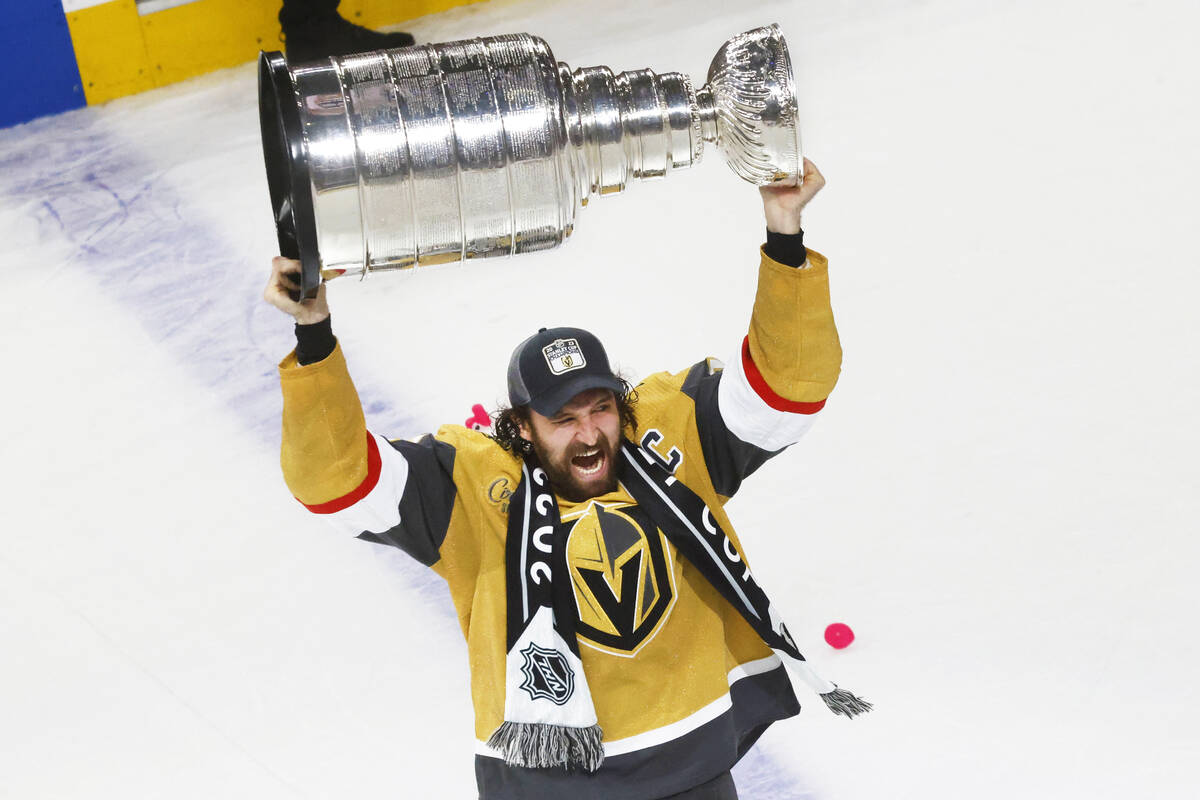 Golden Knights right wing Mark Stone (61) hoists the Stanley Cup after Golden Knights beat Flor ...