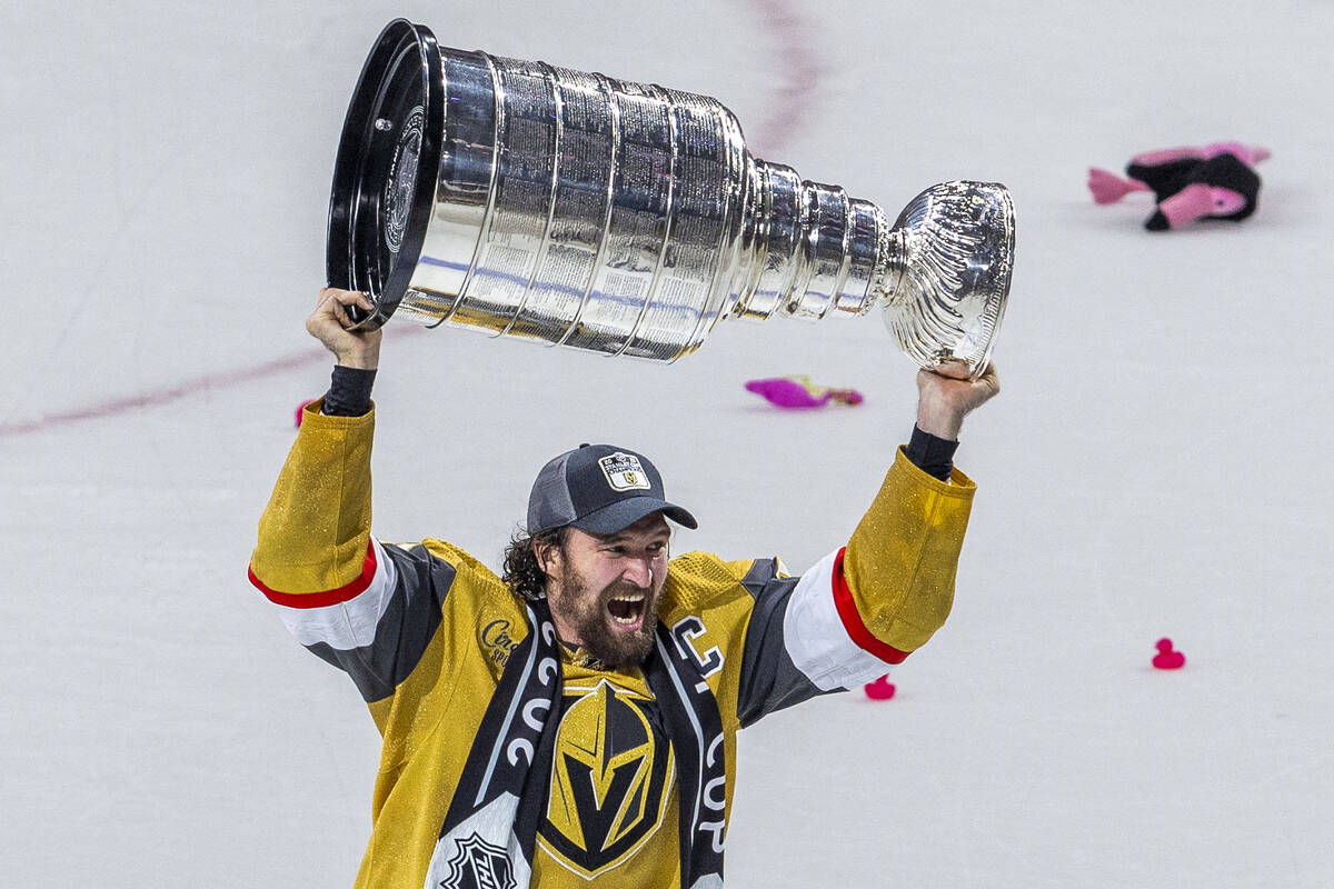 Golden Knights right wing Mark Stone (61) hoists the Stanley Cup after their 9-3 win over the F ...