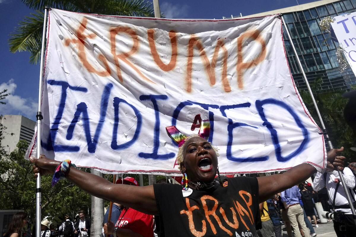 Nadine Seiler holds a banner sign saying "Trump indicted" outside the Wilkie D. Ferguson Jr. U. ...