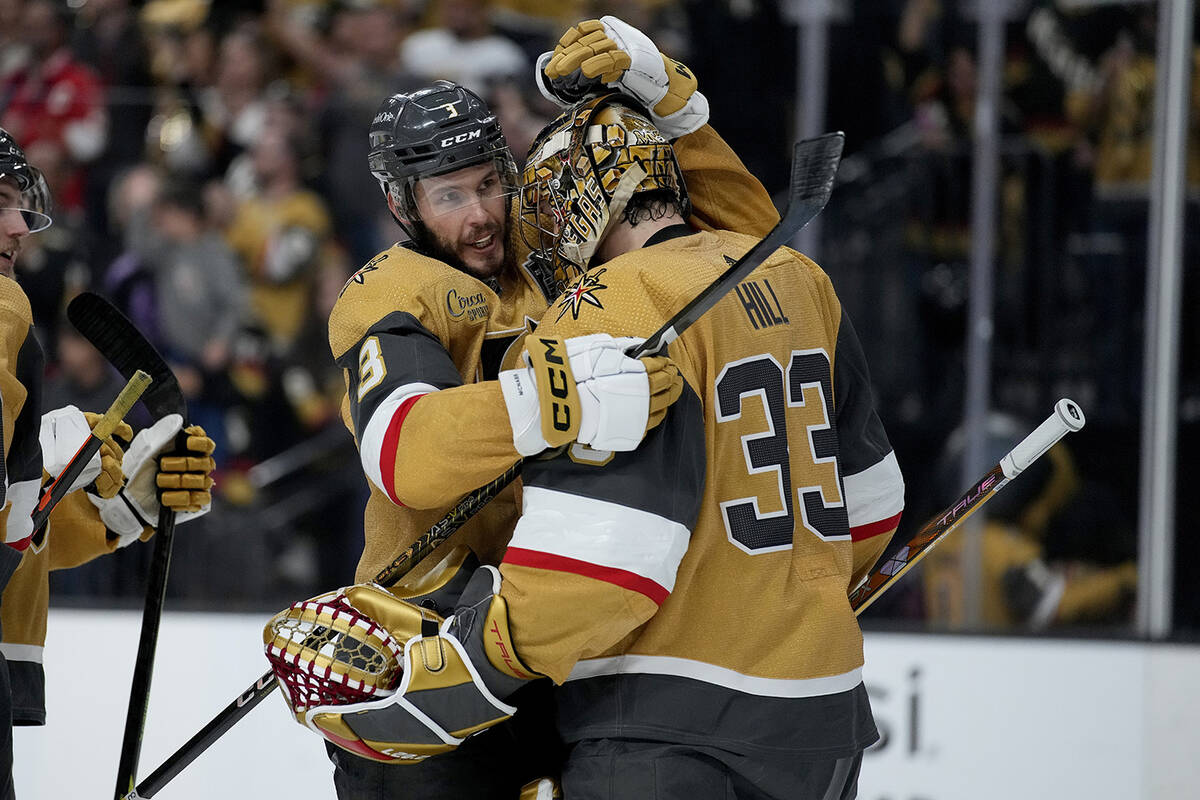 Vegas Golden Knights goaltender Adin Hill (33) and defenseman Brayden McNabb (3) celebrate afte ...