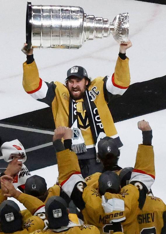 Golden Knights right wing Mark Stone (61) hoists the Stanley Cup after Golden Knights beat Flor ...