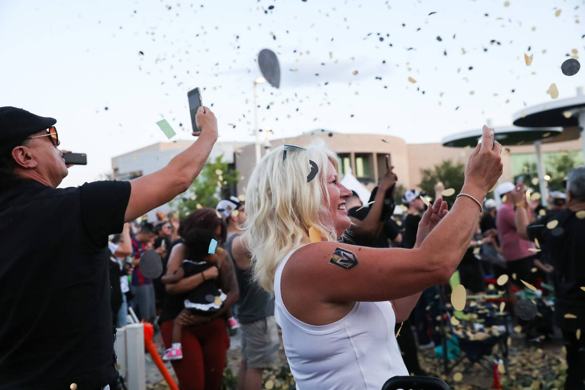 Fans celebrate the Golden Knights winning the Stanley Cup at the Water Street Plaza watch party ...