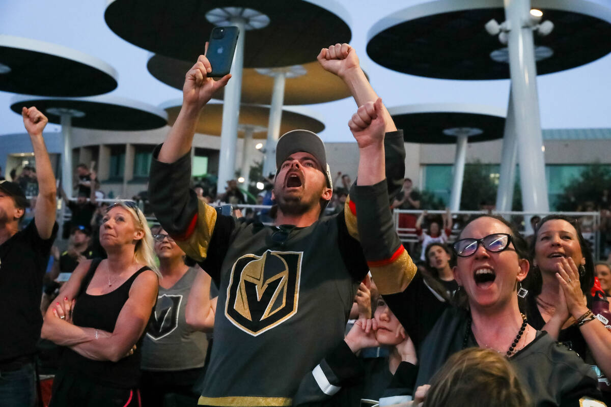 Fans celebrate the Golden Knights winning the Stanley Cup at the Water Street Plaza watch party ...