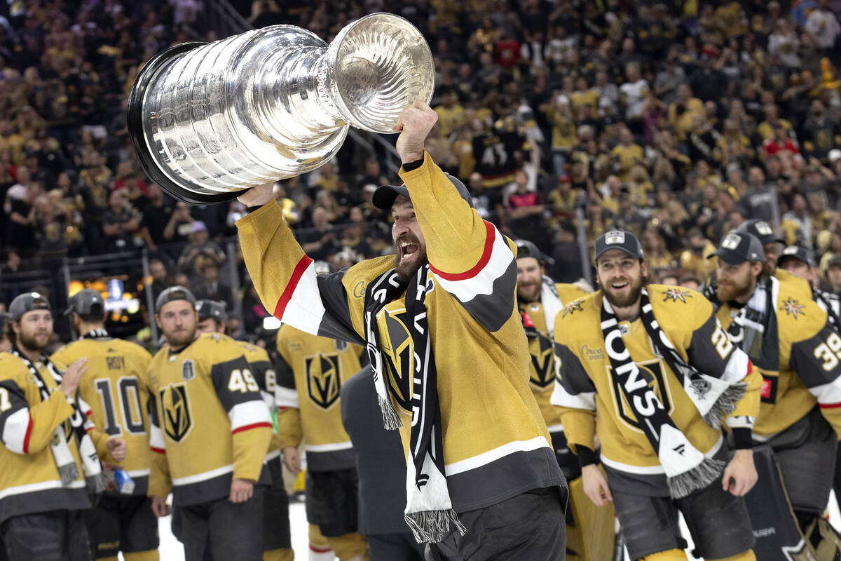 Golden Knights right wing and captain Mark Stone holds up the Stanley Cup after winning Game 5 ...