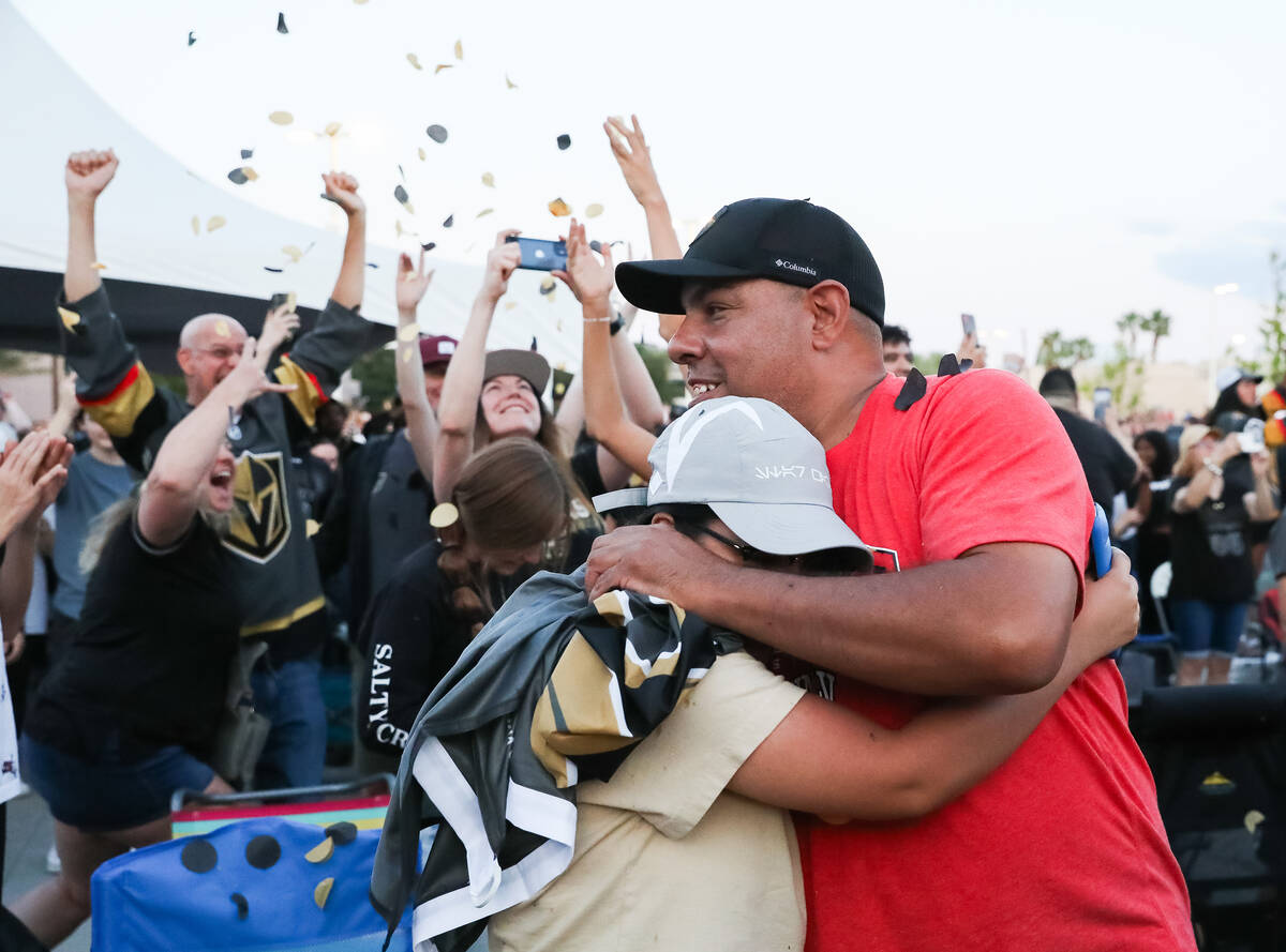 Fans celebrate the Golden Knights winning the Stanley Cup at the Water Street Plaza watch party ...