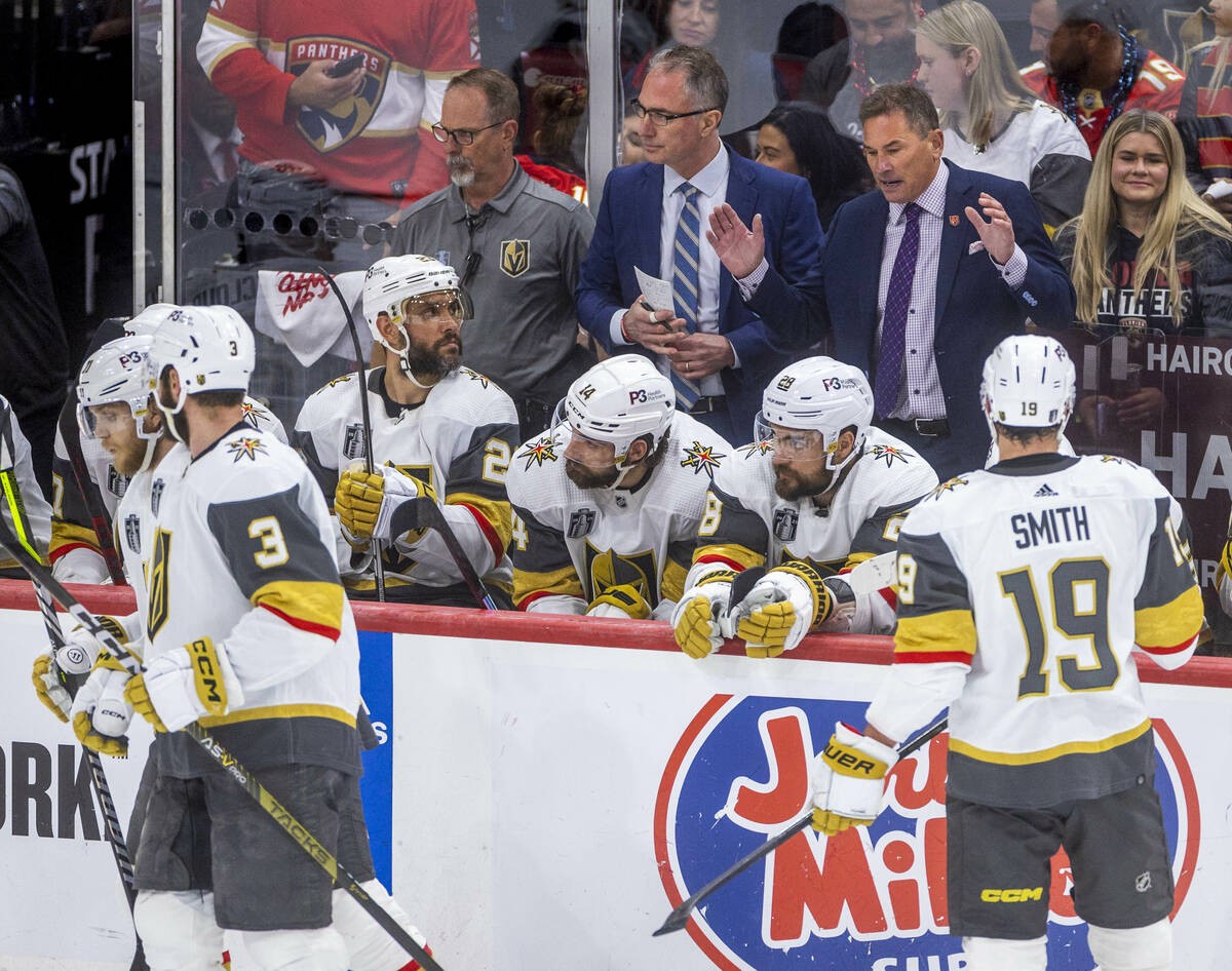 Golden Knights head coach Bruce Cassidy talks to defenseman Alec Martinez (23) and teammates o ...