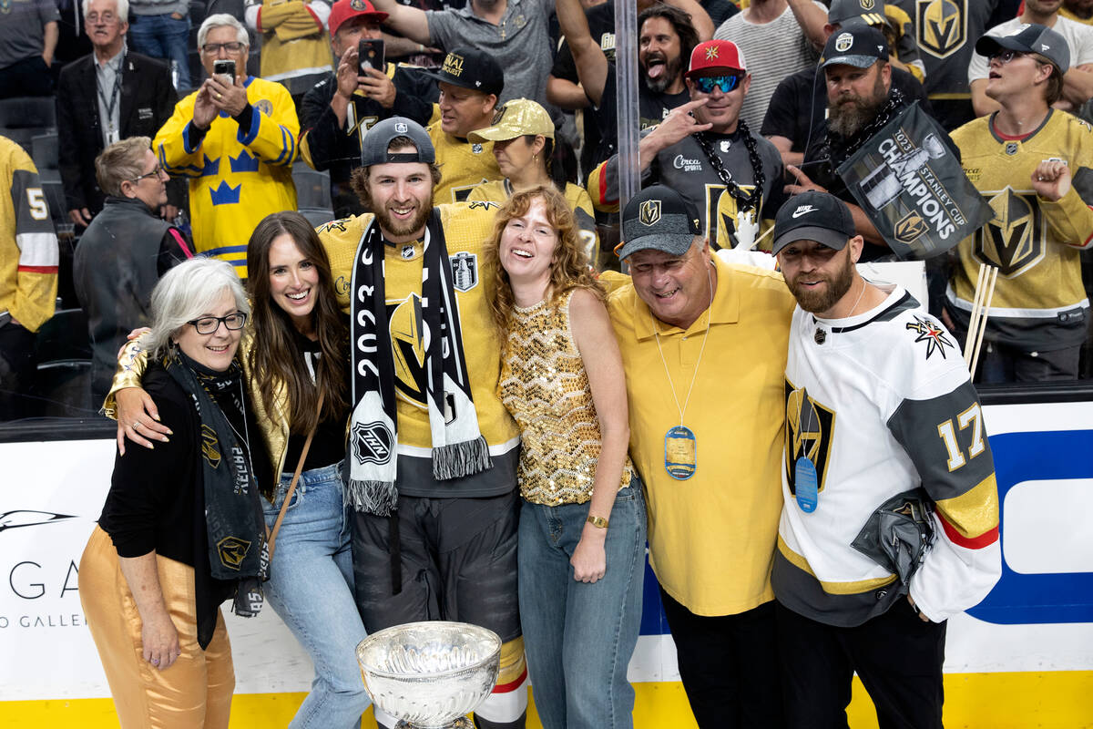 Golden Knights defenseman Ben Hutton (17) poses for a photo with his family and the Stanley Cup ...