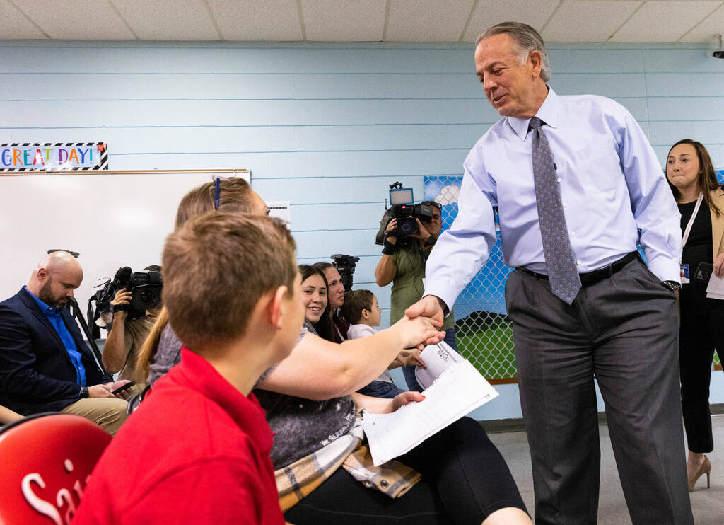 Gov. Joe Lombardo shakes hands with students at Mountain View Christian School and their parent ...