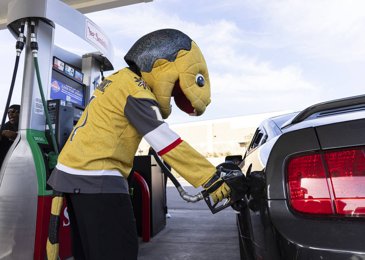 Golden Knights mascot Chance pumps free gas to a customer at Smith’s Marketplace, on Friday, ...