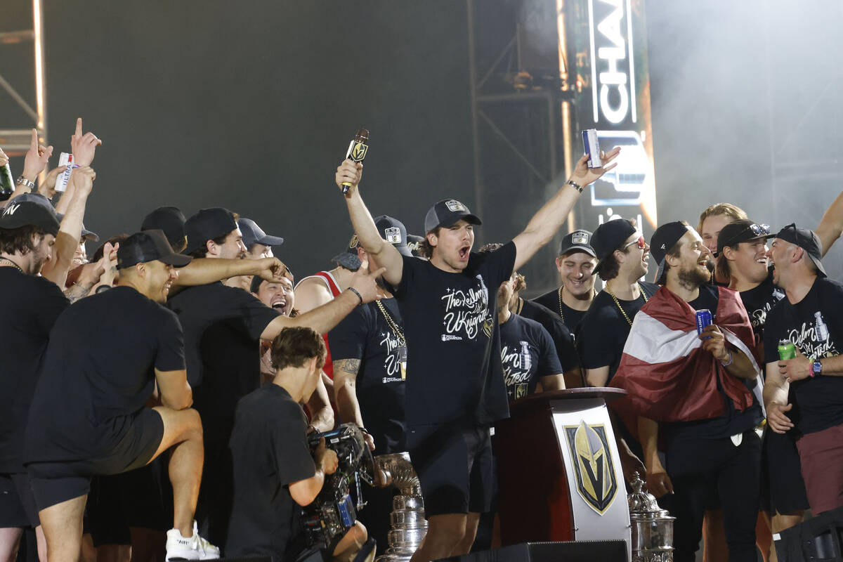 Golden Knights defenseman Shea Theodore, center, celebrates during a rally at Toshiba Plaza aft ...