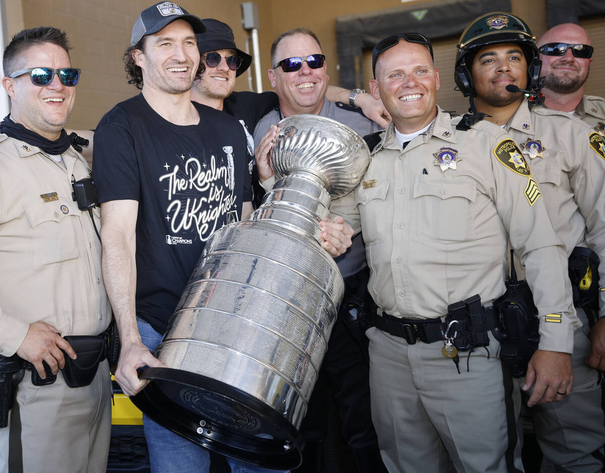 Golden Knights right wing Mark Stone poses for a photo with Las Vegas police officers before th ...