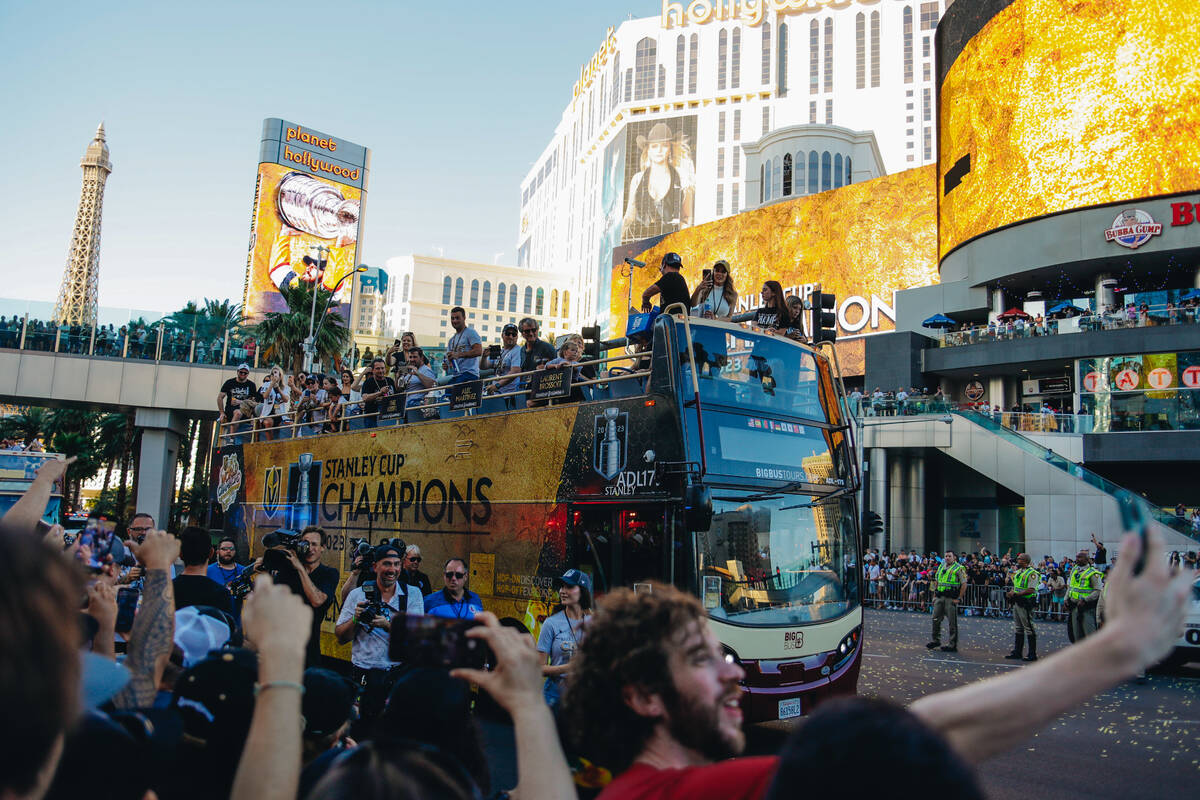 Buses full of Golden Knights players make their way down the Strip during the Stanley Cup champ ...