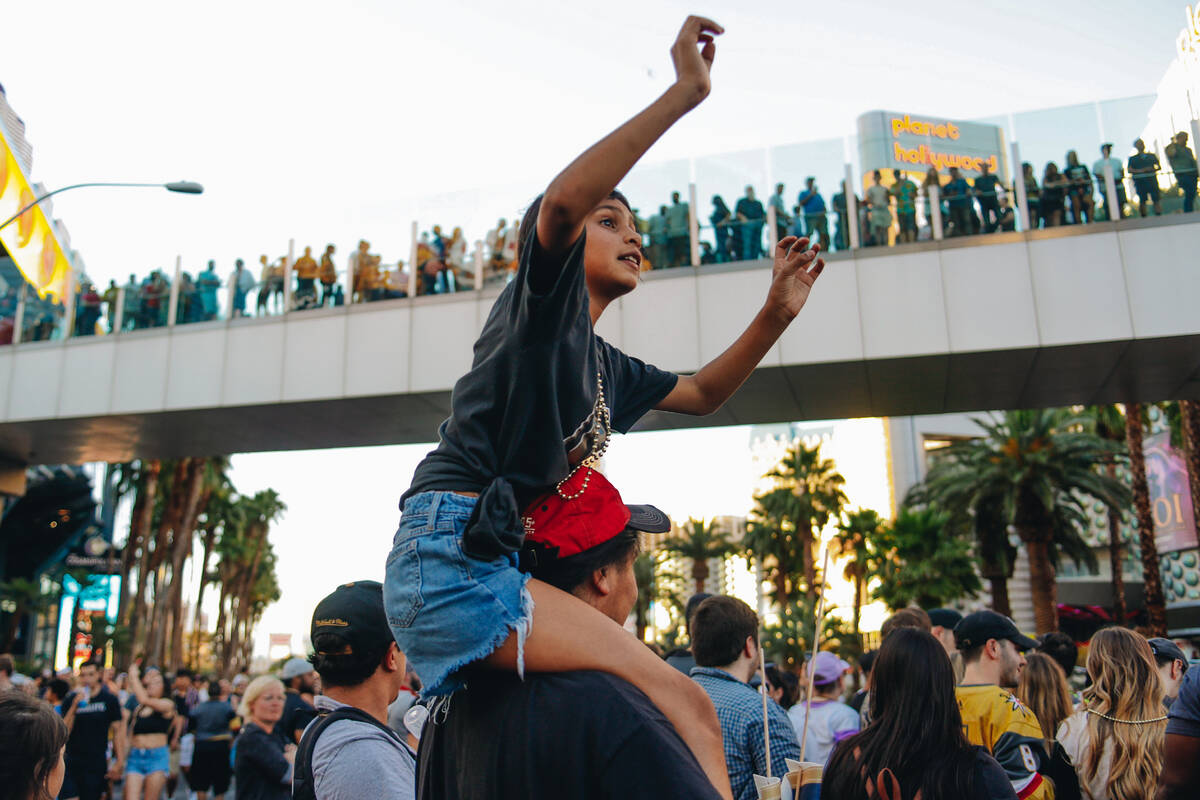 A Golden knights fan waves to players on the busses during the Stanley Cup championship parade ...