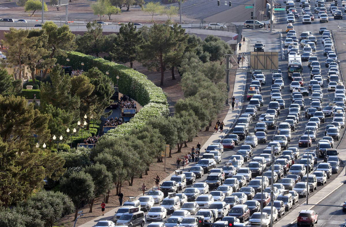 Golden Knights’ Stanley Cup championship busses, left, make their way to the beginning o ...