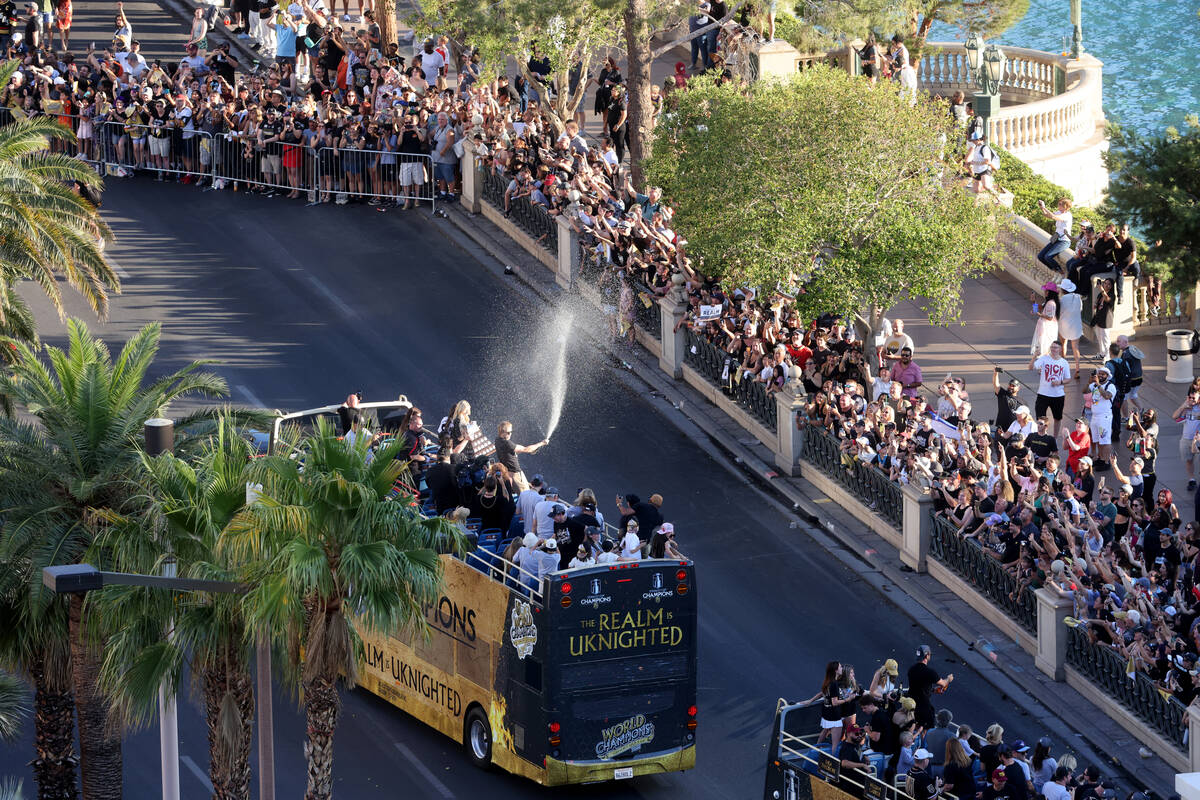 Fans cheer the Golden Knights’ Stanley Cup championship parade on the Strip at Flamingo ...
