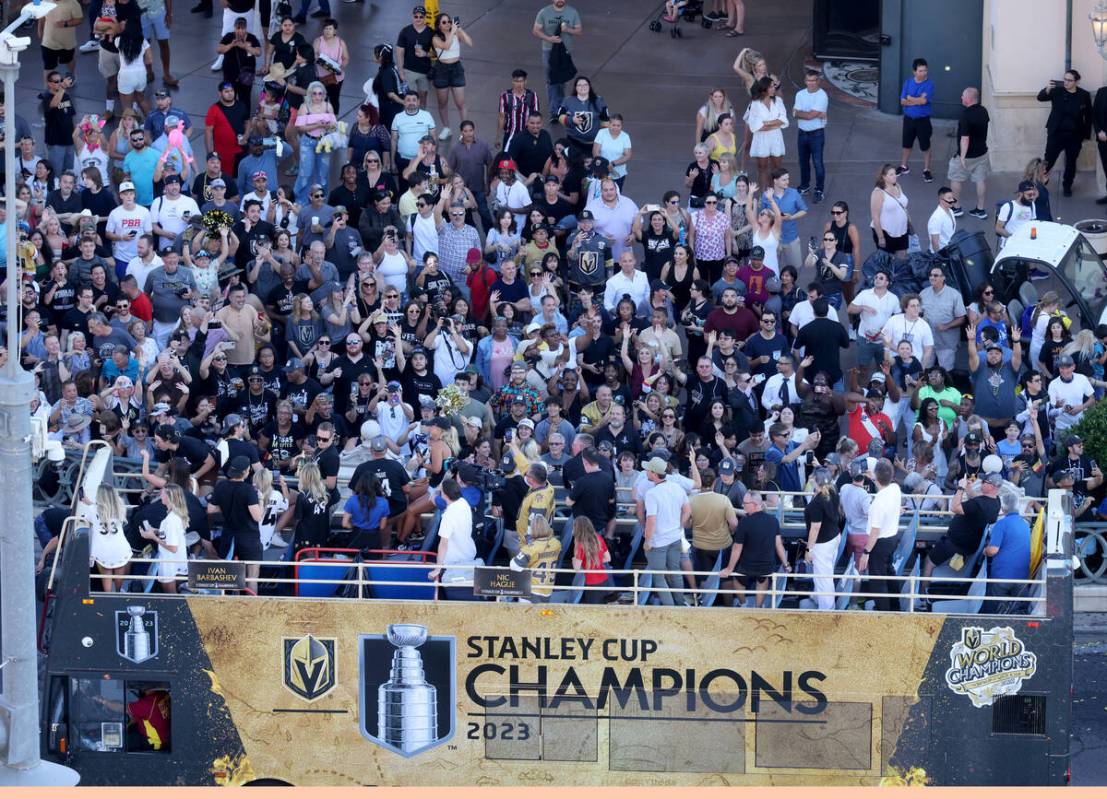 Fans cheer the Golden Knights’ Stanley Cup championship parade on Flamingo Road near the ...