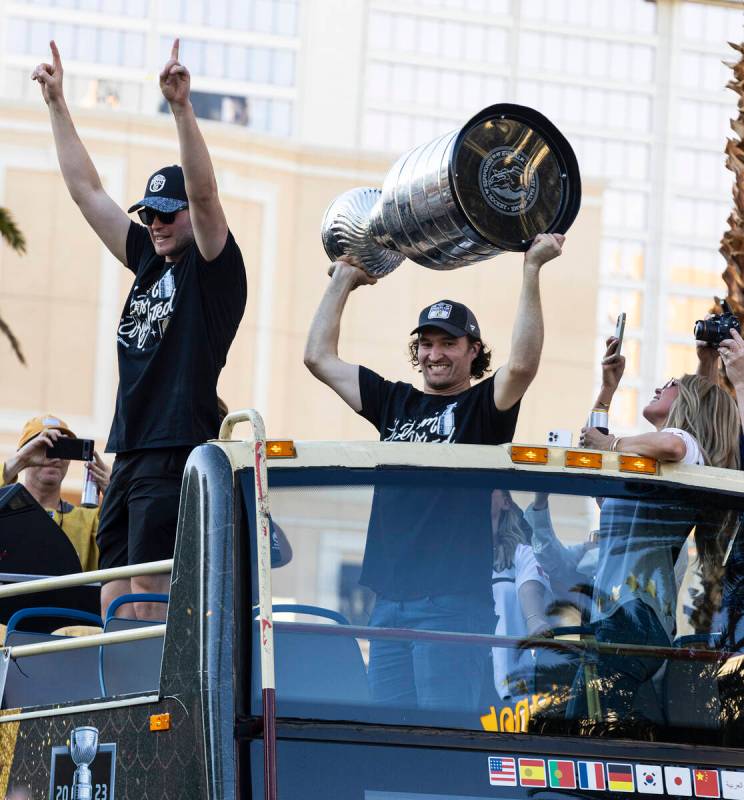 Golden Knights right wing Mark Stone, right, holds the Stanley Cup as he celebrates with fans d ...