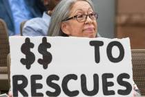 Patricia Reid, who opposes funding The Animal Foundation, holds a sign as she attend the Clark ...