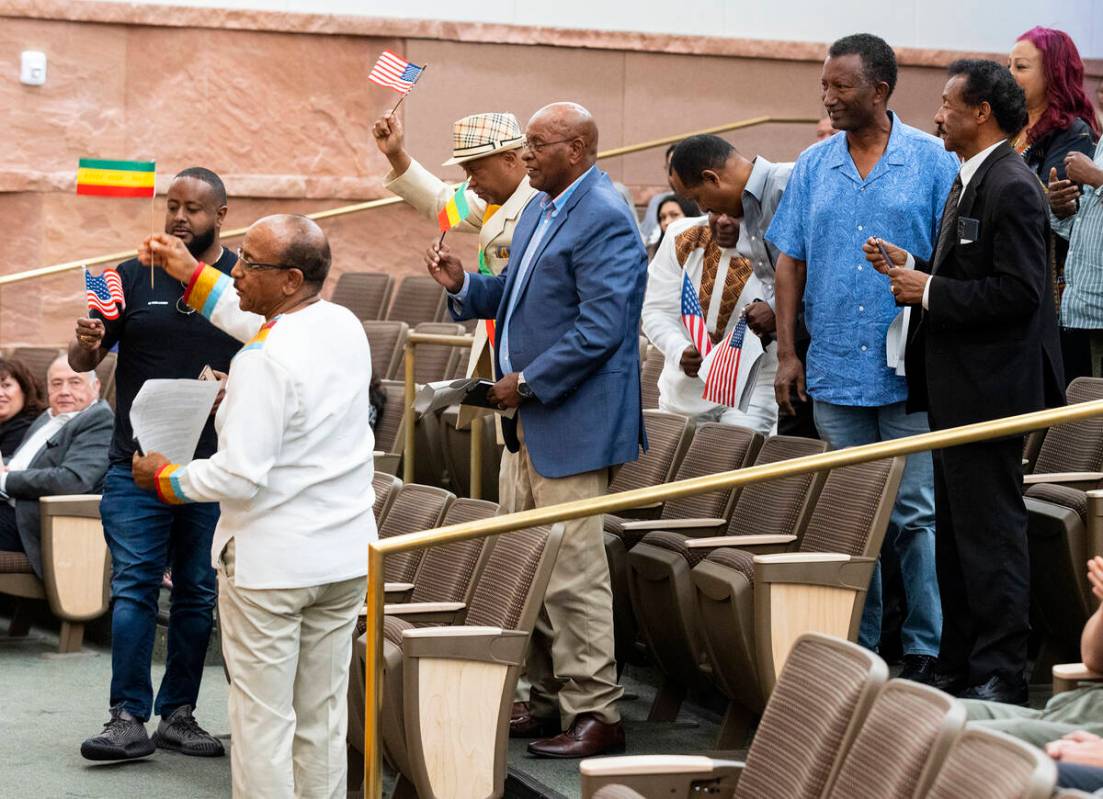 People wave Ethiopian and American flags as they cheer in the Clark County Commission chambers ...