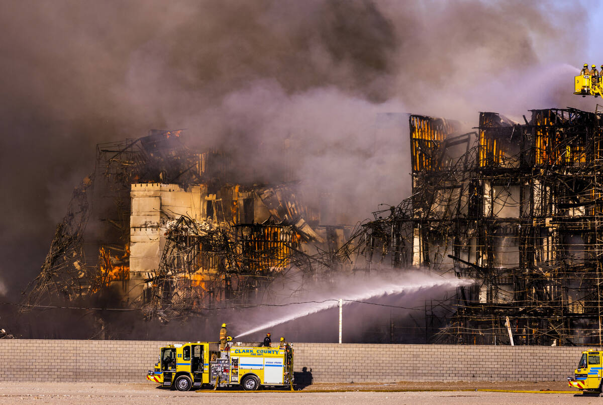 Firefighters work to extinguish a blaze at an under-construction residential complex near Buffa ...