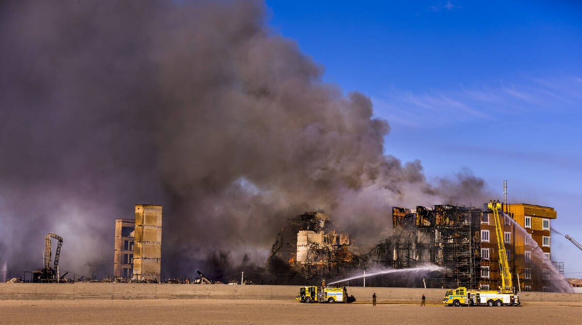 Firefighters work to extinguish a blaze at an under-construction residential complex near Buffa ...