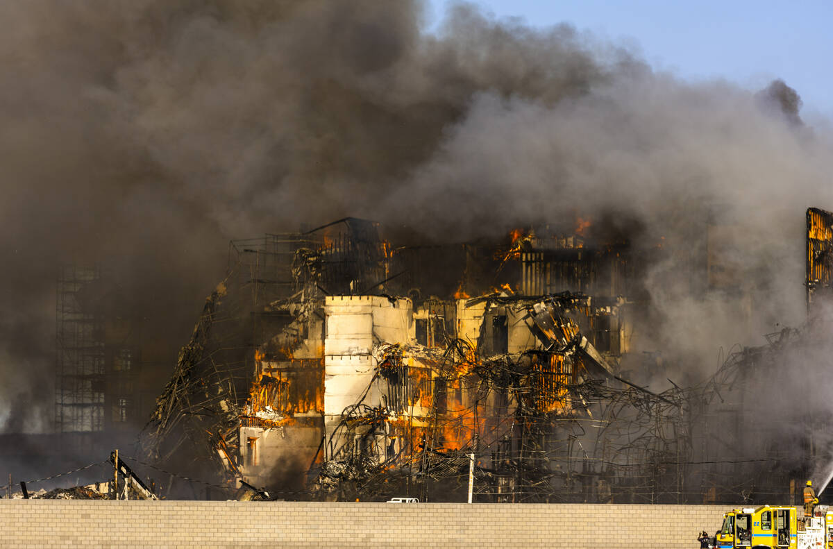 Firefighters work to extinguish a blaze at an under-construction residential complex near Buffa ...