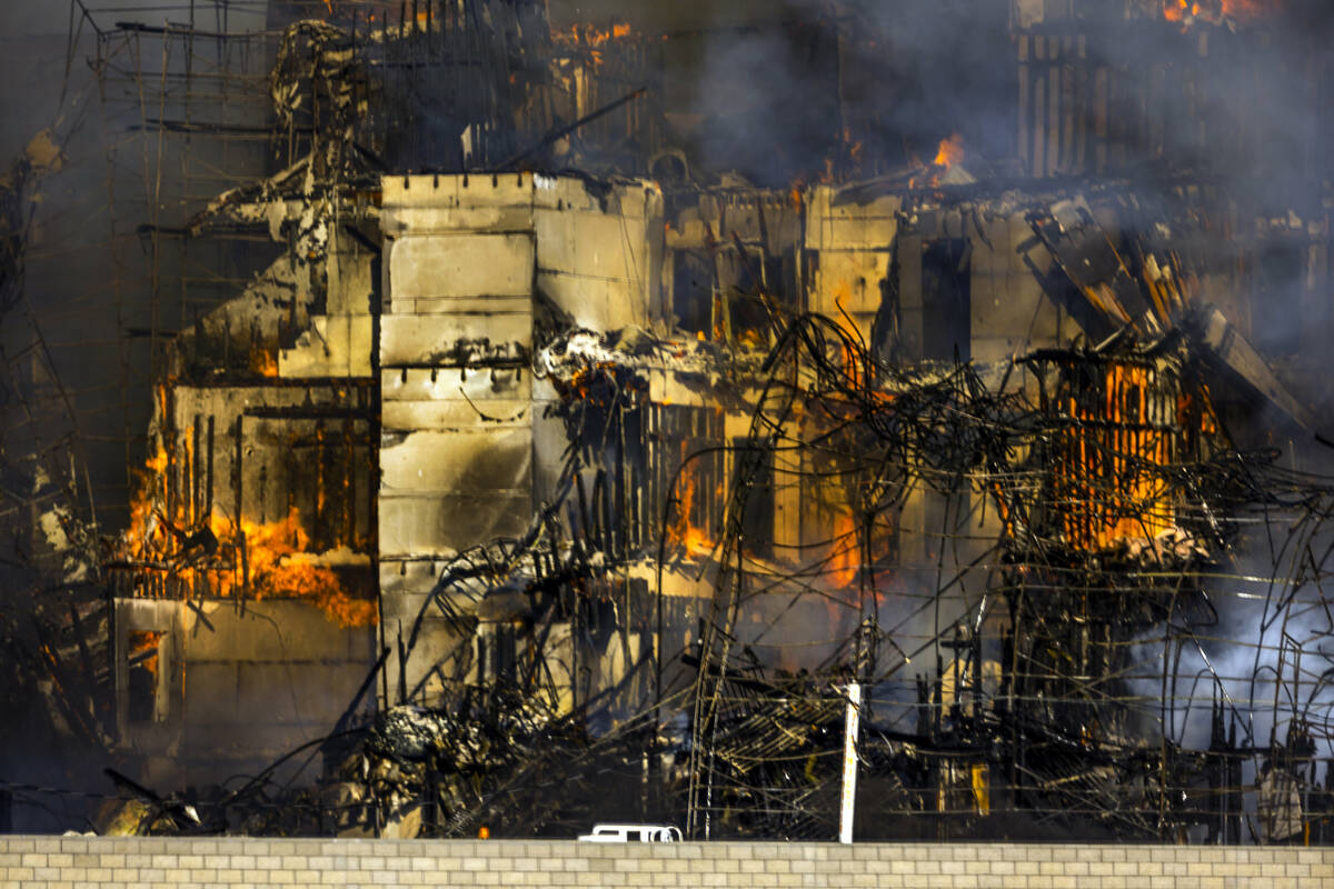 Firefighters work to extinguish a blaze at an under-construction residential complex near Buffa ...