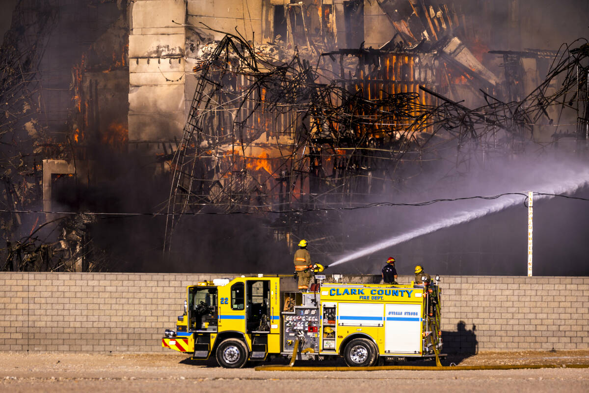 Firefighters work to extinguish a blaze at an under-construction residential complex near Buffa ...