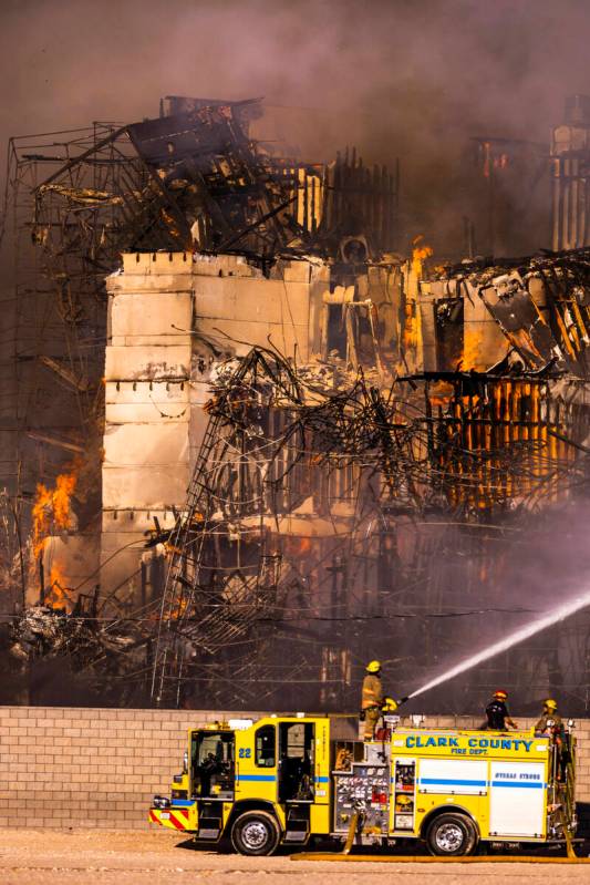 Firefighters work to extinguish a blaze at an under-construction residential complex near Buffa ...