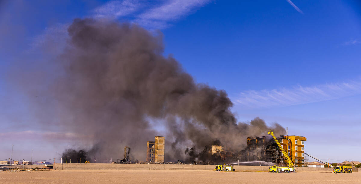 Firefighters work to extinguish a blaze at an under-construction residential complex near Buffa ...