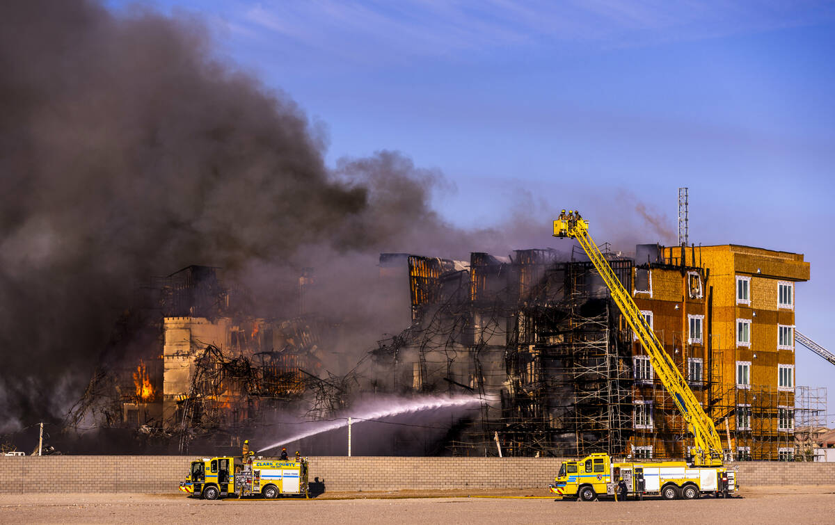 Firefighters work to extinguish a blaze at an under-construction residential complex near Buffa ...