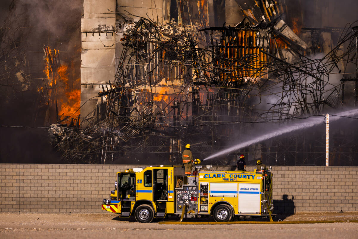 Firefighters work to extinguish a blaze at an under-construction residential complex near Buffa ...