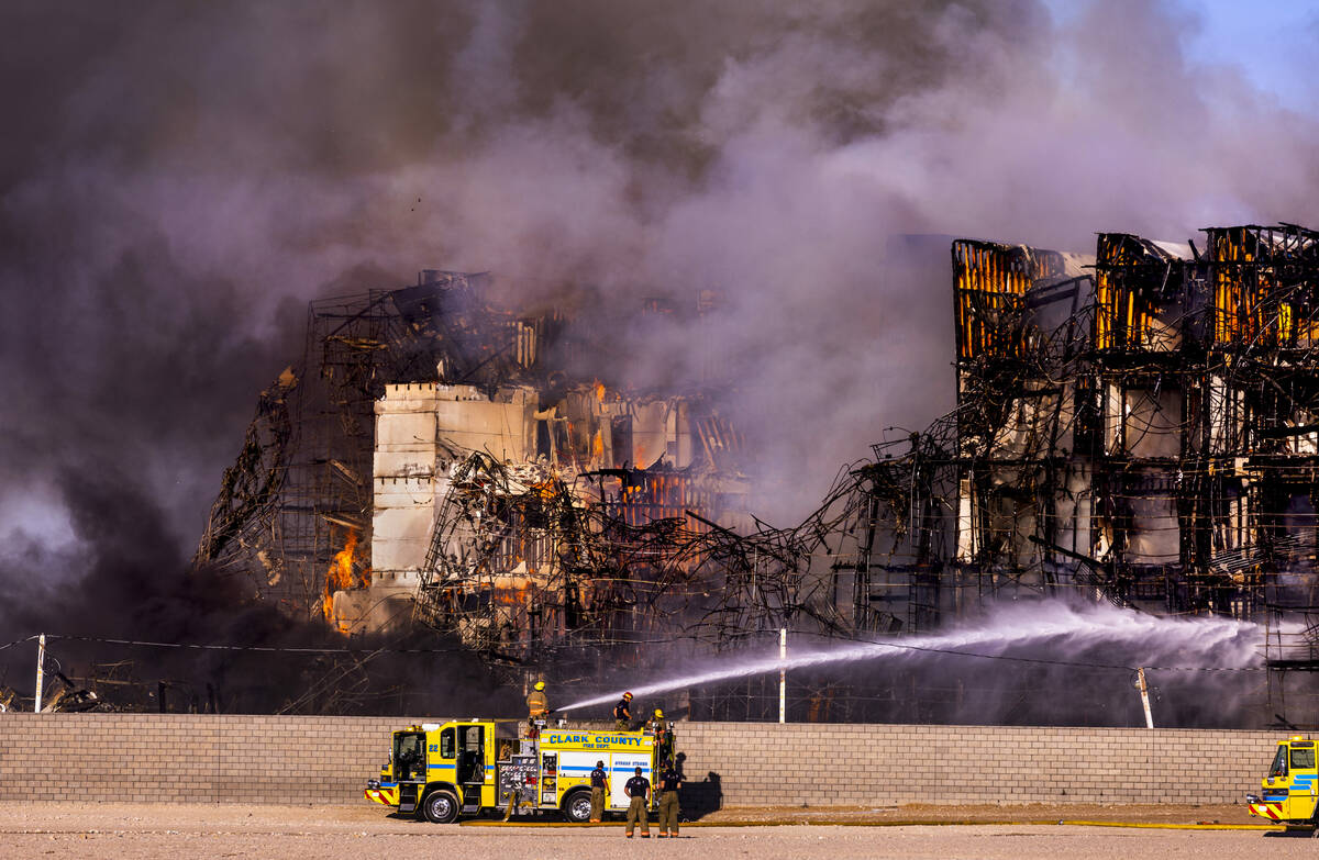 Firefighters work to extinguish a blaze at an under-construction residential complex near Buffa ...