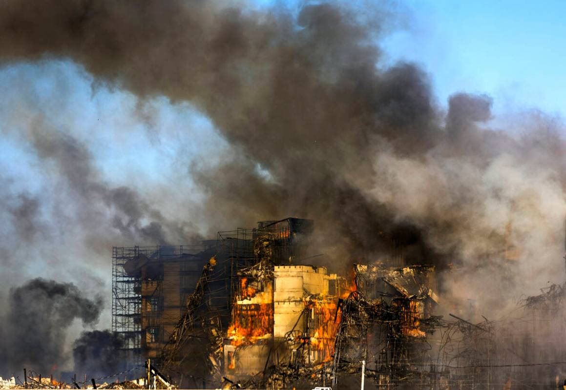 Firefighters work to extinguish a blaze at an under-construction residential complex near Buffa ...