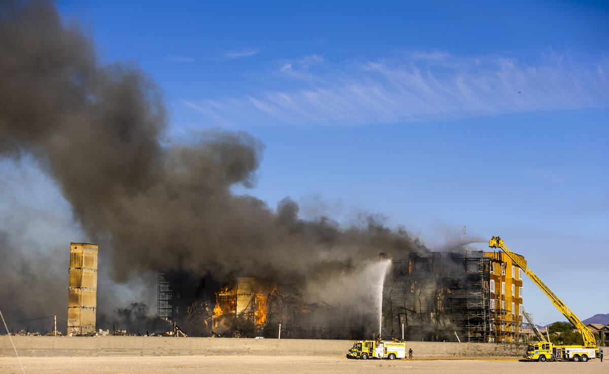 Firefighters work to extinguish a blaze at an under-construction residential complex near Buffa ...