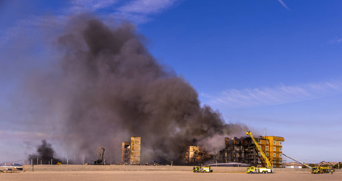 Firefighters work to extinguish a blaze at an under-construction residential complex near Buffa ...