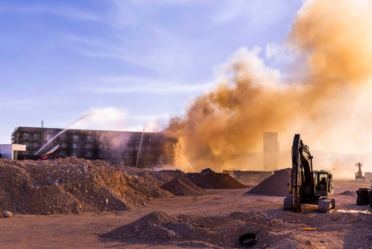 Firefighters work to extinguish a blaze at an under-construction residential complex near Buffa ...