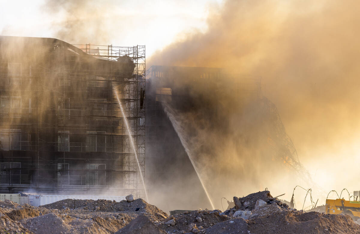 Firefighters work to extinguish a blaze at an under-construction residential complex near Buffa ...