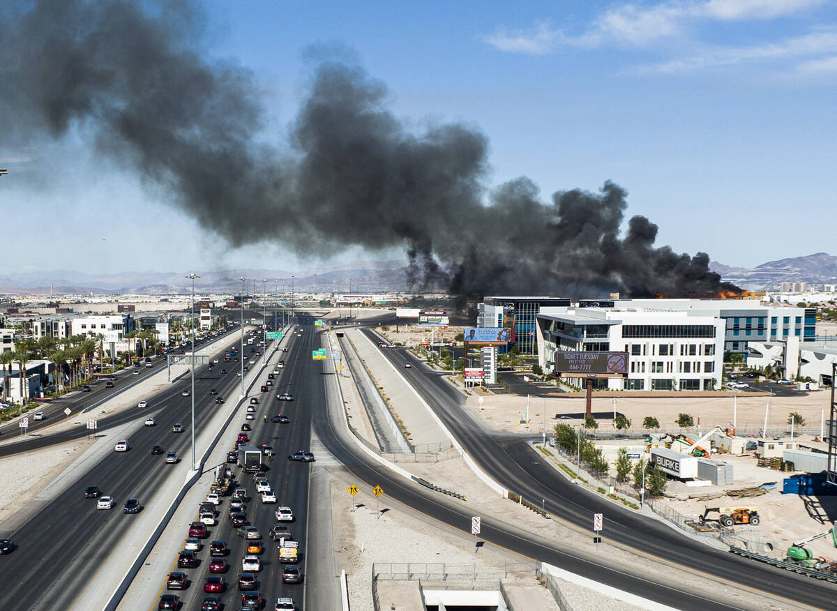 Heavy smoke is seen as firefighters work to extinguish a blaze at an under-construction residen ...