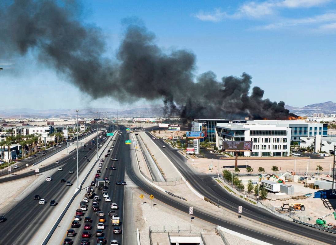 Heavy smoke is seen as firefighters work to extinguish a blaze at an under-construction residen ...