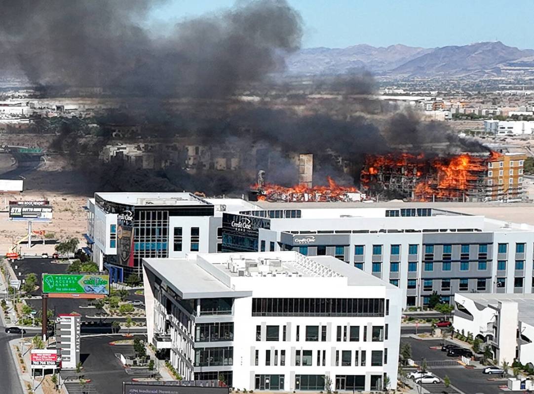 Heavy smoke is seen as firefighters work to extinguish a blaze at an under-construction residen ...