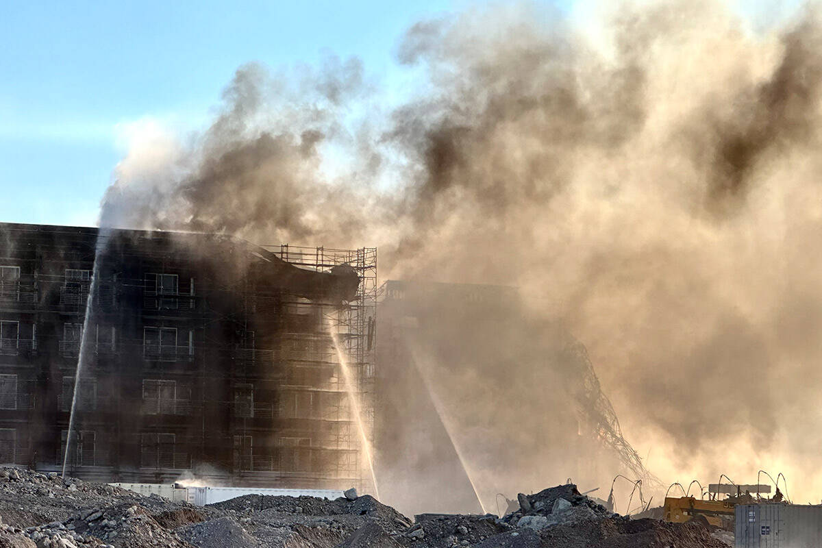 Firefighters work to extinguish a blaze at an under-construction residential complex near Buffa ...