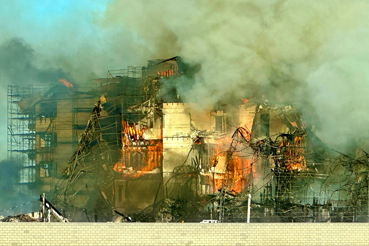 Firefighters work to extinguish a blaze at an under-construction residential complex near Buffa ...