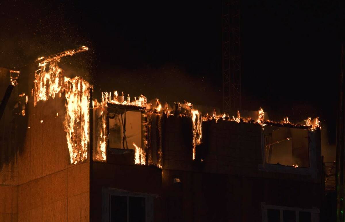 Firefighters work to extinguish a blaze at an under-construction residential complex near Buffa ...