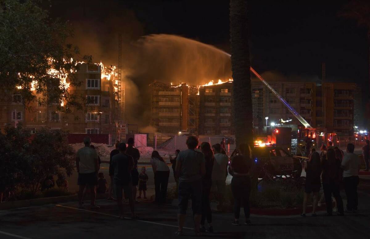 Firefighters work to extinguish a blaze at an under-construction residential complex near Buffa ...