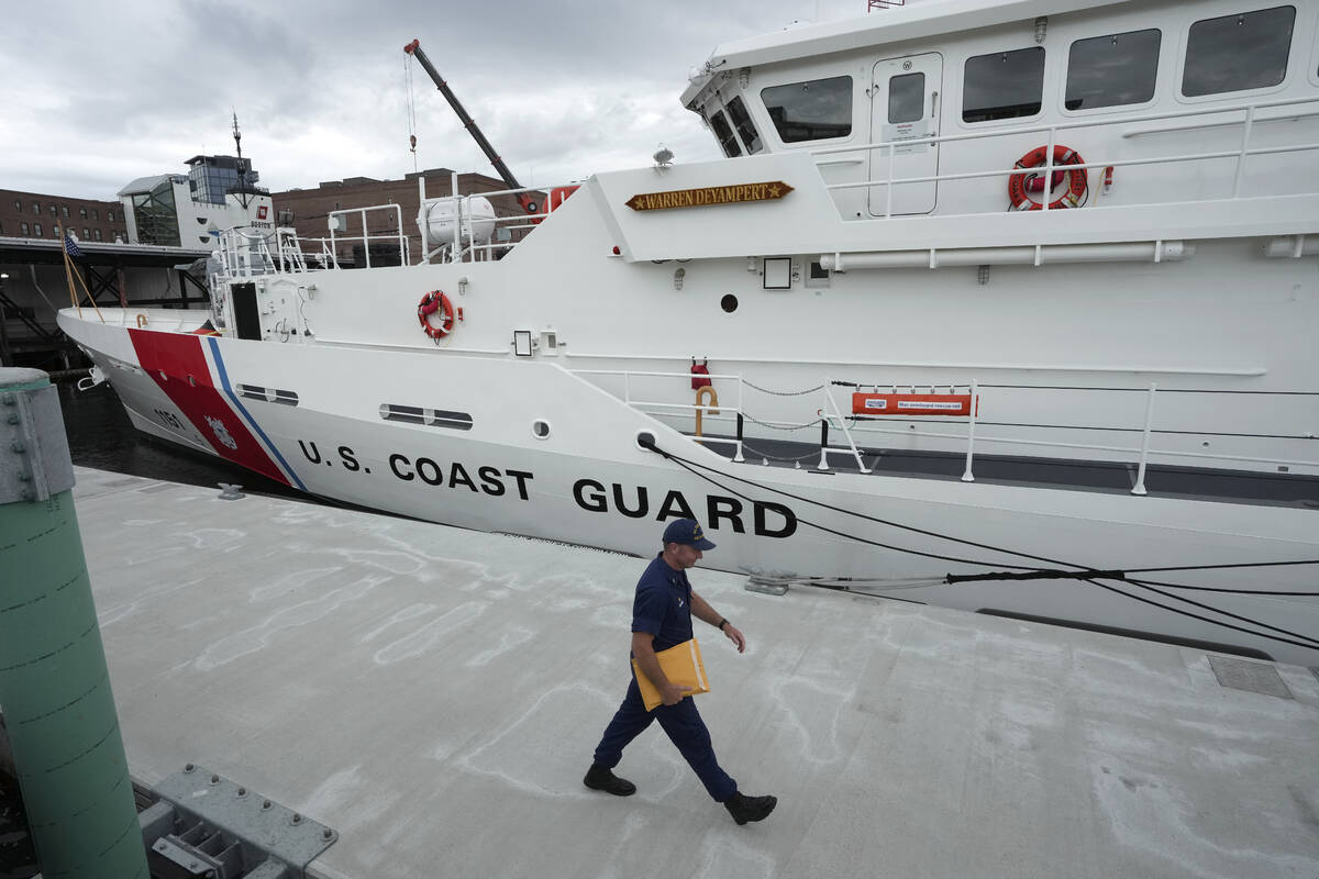 The U.S. Coast Guard Cutter Warren Deyampert is docked as a member of the Coast Guard walks pas ...