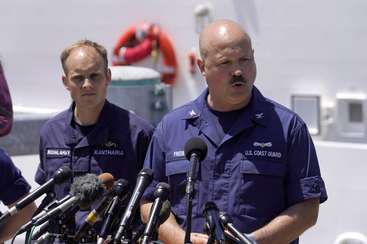 U.S. Coast Guard Capt. Jamie Frederick, right, faces reporters as Royal Navy Lt Cdr Rich Kantha ...